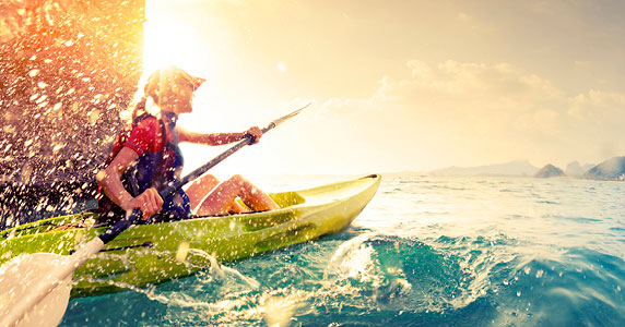 Women kayaking during sunset